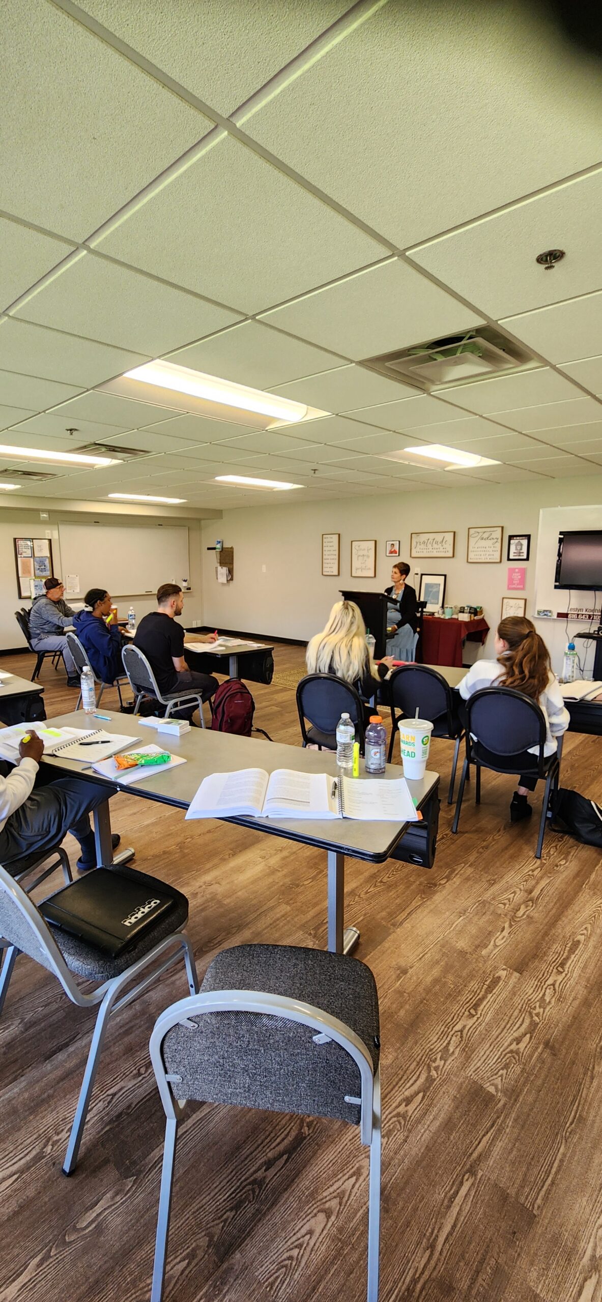 A group of people sitting around tables in a room.